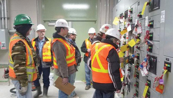 The Site Safety and Commissioning Team at YEC performing a Lock Out Tag Out procedure in the Motor Control Room as part of the safe commissioning of the facility. 