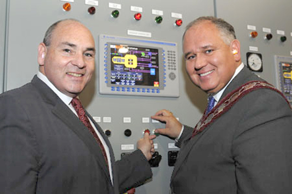The Hon. George Smitherman, Minister of Energy and Infrastructure, and Frank Scarpitti, Mayor of Markham, at the controls of Markham District Energy, on April 20.