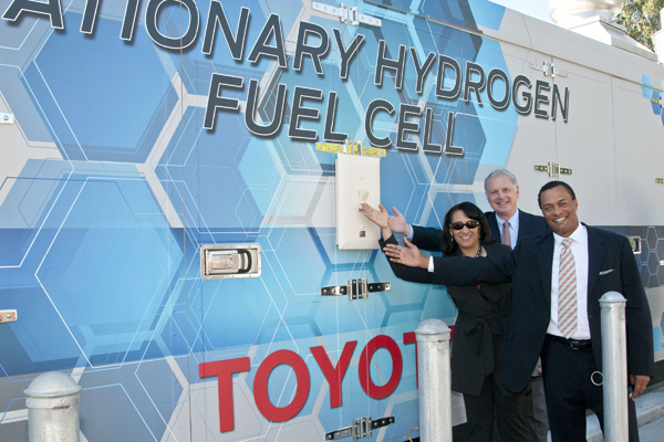 Officials at Toyota Motor Sales throw the ceremonial switch on Ballard's fuel cell.