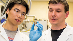 Co-authors Zhijun Ning (left) and Oleksandr Voznyy (right) examine a film coated with colloidal quantum dots. Photo: Roberta Baker